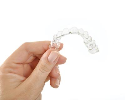 hand holding clear aligners in germantown