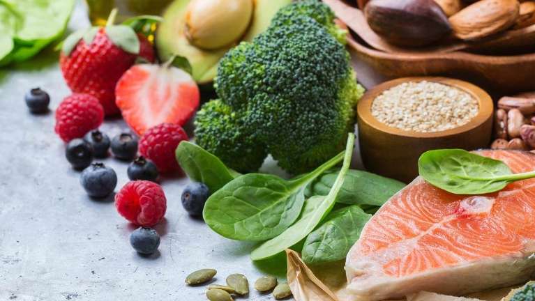 an assortment of vegetables, grains, fruit, and fish